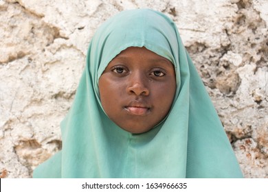 Zanzibar, Tanzania - december 09, 2019 : Unidentified african girl near a local school after class in island Zanzibar, Tanzania, East Africa