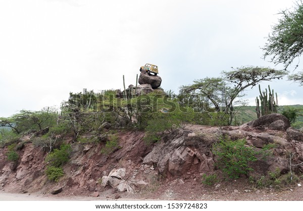 Zapatoca / Santander /\
Colombia; October 09, 2019: Car mounted on rocks on the road that\
leads to the municipality of Zapatoca at the height of the\
Chicamocha River\
Canyon