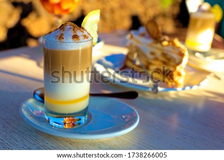 Zaperoco caffee and cake on the table in golden sun. Tenerife,  Puerto de la Cruz, Tarao Garden.