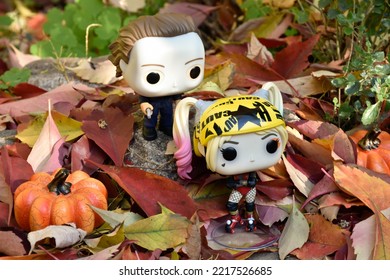 Zaporizhzhia, Ukraine - October 19, 2022: Funko Pop Action Figures. Serial Killer Michael Myers From Horror Movie Halloween Attacking With Knife Harley Quinn In Fall Garden. Autumn Leaves, Pumpkins.