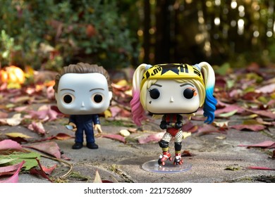 Zaporizhzhia, Ukraine - October 19, 2022: Funko Pop Action Figures Of Serial Killer Michael Myers From Horror Movie Halloween And Harley Quinn Walking Down Street, Park, Fall Leaves, Spooky Season.