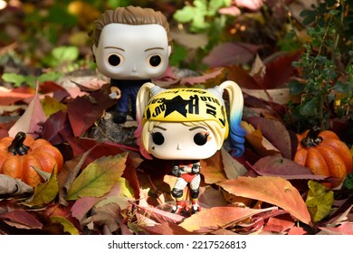 Zaporizhzhia, Ukraine - October 19, 2022: Funko Pop Action Figures. Serial Killer Michael Myers From Horror Movie Halloween Attacking With Knife Harley Quinn Walking In Fall Garden. Spooky Season. 