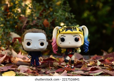 Zaporizhzhia, Ukraine - October 19, 2022: Funko Pop Action Figures Of Serial Killer Michael Myers From Horror Movie Halloween And Harley Quinn Walking Down Street, Park, Fall Leaves, Spooky Season.