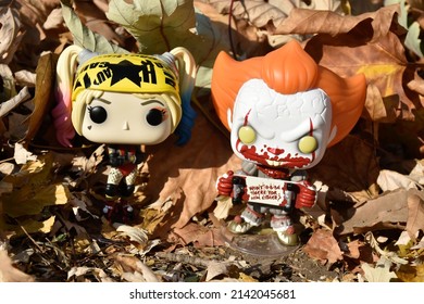 Zaporizhzhia, Ukraine - October 22, 2021: Illustrative Editorial Of Funko Pop Action Figures Of Harley Quinn From Birds Of Prey And Evil Clown Pennywise From Horror Movie It. Toys In Fallen Leaves.