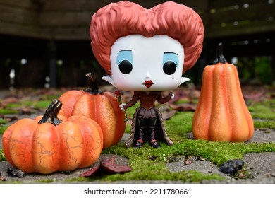 Zaporizhzhia, Ukraine - October 4, 2022: Funko Pop Action Figure Of Red Queen From Tim Burton Movie Alice In Wonderland. Green Moss, Fabulous Autumn Garden, Fallen Leaves, Halloween Pumpkins Decor.