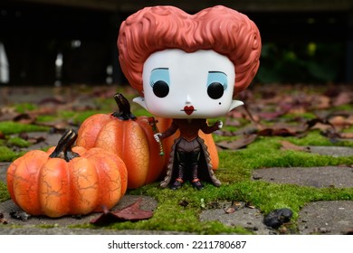 Zaporizhzhia, Ukraine - October 4, 2022: Funko Pop Action Figure Of Red Queen From Tim Burton Movie Alice In Wonderland. Green Moss, Fabulous Autumn Garden, Fallen Leaves, Halloween Pumpkins Decor.