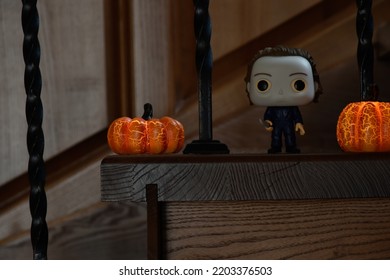 Zaporizhzhia, Ukraine - September 16, 2022: Funko Pop Vinyl Action Figure Of Serial Killer Michael Myers From Popular Horror Movie Halloween. Wooden Stairs In Dark House, Pumpkins, Spooky Atmosphere.