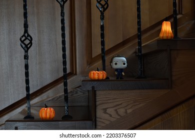 Zaporizhzhia, Ukraine - September 16, 2022: Funko Pop Vinyl Action Figure Of Serial Killer Michael Myers From Popular Horror Movie Halloween. Wooden Stairs In Dark House, Pumpkins, Spooky Atmosphere.