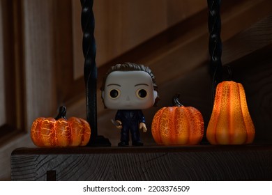 Zaporizhzhia, Ukraine - September 16, 2022: Funko Pop Vinyl Action Figure Of Serial Killer Michael Myers From Popular Horror Movie Halloween. Wooden Stairs In Dark House, Pumpkins, Spooky Atmosphere.