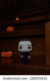 Zaporizhzhia, Ukraine - September 16, 2022: Funko Pop Vinyl Action Figure Of Serial Killer Michael Myers From Popular Horror Movie Halloween. Wooden Stairs In Dark House, Pumpkins, Spooky Atmosphere.