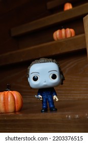 Zaporizhzhia, Ukraine - September 16, 2022: Funko Pop Vinyl Action Figure Of Serial Killer Michael Myers From Popular Horror Movie Halloween. Wooden Stairs In Dark House, Pumpkins, Spooky Atmosphere.