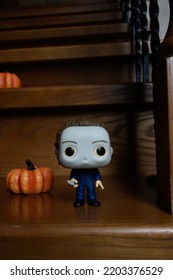 Zaporizhzhia, Ukraine - September 16, 2022: Funko Pop Vinyl Action Figure Of Serial Killer Michael Myers From Popular Horror Movie Halloween. Wooden Stairs In Dark House, Pumpkins, Spooky Atmosphere.