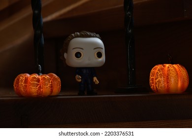 Zaporizhzhia, Ukraine - September 16, 2022: Funko Pop Vinyl Action Figure Of Serial Killer Michael Myers From Popular Horror Movie Halloween. Wooden Stairs In Dark House, Pumpkins, Spooky Atmosphere.