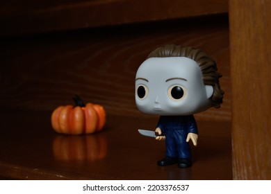 Zaporizhzhia, Ukraine - September 16, 2022: Funko Pop Vinyl Action Figure Of Serial Killer Michael Myers From Popular Horror Movie Halloween. Wooden Stairs In Dark House, Pumpkin, Spooky Atmosphere.