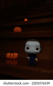 Zaporizhzhia, Ukraine - September 16, 2022: Funko Pop Vinyl Action Figure Of Serial Killer Michael Myers From Popular Horror Movie Halloween. Wooden Stairs In Dark House, Pumpkins, Spooky Atmosphere.