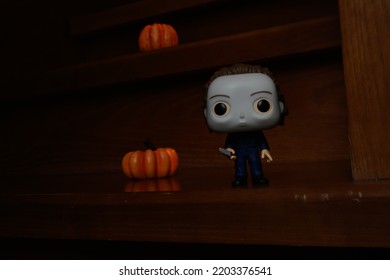 Zaporizhzhia, Ukraine - September 16, 2022: Funko Pop Vinyl Action Figure Of Serial Killer Michael Myers From Popular Horror Movie Halloween. Wooden Stairs In Dark House, Pumpkins, Spooky Atmosphere.