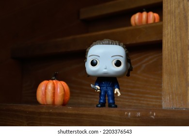 Zaporizhzhia, Ukraine - September 16, 2022: Funko Pop Vinyl Action Figure Of Serial Killer Michael Myers From Popular Horror Movie Halloween. Wooden Stairs In Dark House, Pumpkins, Spooky Atmosphere.