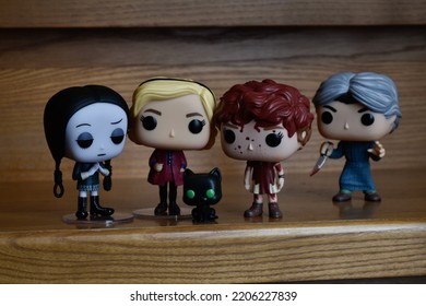 Zaporizhzhia, Ukraine - September 22, 2022: Funko Pop Vinyl Collection Action Figures Of Wednesday Addams, Sabrina Spellman, Beverly Marsh And Norman Bates Attacking Them With Knife On Wooden Stairs.