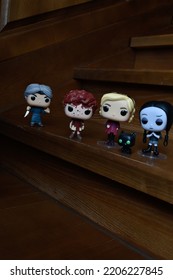 Zaporizhzhia, Ukraine - September 22, 2022: Funko Pop Vinyl Collection Action Figures Of Beverly Marsh, Sabrina Spellman, Wednesday Addams And Norman Bates Attacking Them With Knife On Wooden Stairs.