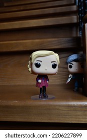 Zaporizhzhia, Ukraine - September 22, 2022: Funko Pop Action Figures Of Sabrina Spellman And Norman Bates From Movie Psycho. Killer Attacking Teenage Witch With Knife On Dark Wooden Stairs. 