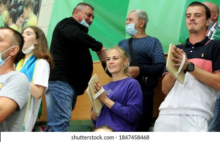 ZAPOROZHYA, UKRAINE - 09/20/2020- Spectators And Fans Emotionally During The COVID19 Pandemic In Masks Support Their Team In Stands Of Indoor Sports Hall Of Stadium. Sports Fans During  COVID Epidemic