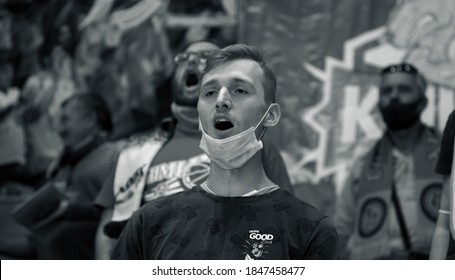 ZAPOROZHYA, UKRAINE - 09/20/2020- Spectators And Fans Emotionally During The COVID19 Pandemic In Masks Support Their Team In Stands Of Indoor Sports Hall Of Stadium. Sports Fans During  COVID Epidemic