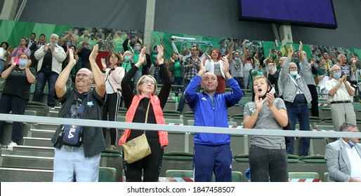 ZAPOROZHYA, UKRAINE - 09/20/2020- Spectators And Fans Emotionally During The COVID19 Pandemic In Masks Support Their Team In Stands Of Indoor Sports Hall Of Stadium. Sports Fans During  COVID Epidemic