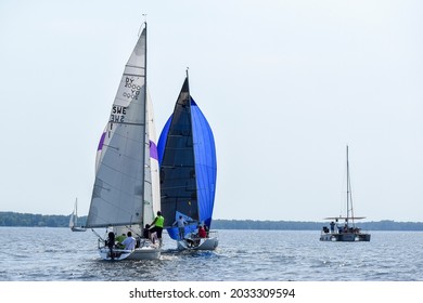 Zaporozhye, Ukraine - August 21, 2021: Two Sailing Yachts With Colored Sails In A Race And Trimaran, Rear View, Editorial