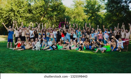 Zaporozhye, Ukraine-August 2018 Pool Party In The Company Ovoh. A Large Group Of Friends Are Photographed On A Green Lawn.