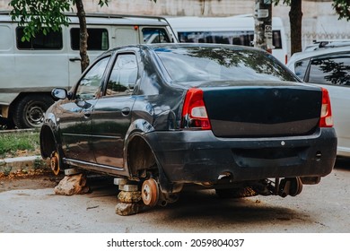 Zaporozhye,Ukraine - July 14 2020 : A broken passenger car without wheels stands on bricks