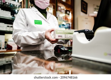 Zaragoza, Spain; December, 2021. A Pharmacist Cashier Scan And Process A Covid Test Payment Through The Computer