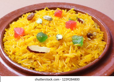 Zarda rice, Closeup of indian or pakistani sweet rice dish in a clay bowl on white background, Traditional asian food. 