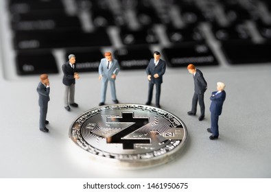 Zcash (ZEC) Coin And Businessmans On Notebook. Digital Cyber Safety Or Security Encryption. Manage Bitcoin Price Schedule Concept. Money Laundering Bitcoin Concept. Market Manipulation.