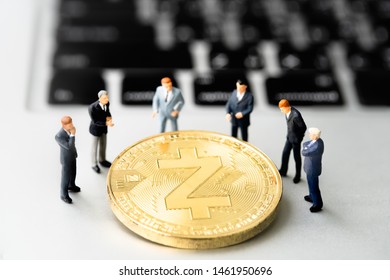 Zcash (ZEC) Coin And Businessmans On Notebook. Digital Cyber Safety Or Security Encryption. Manage Bitcoin Price Schedule Concept. Money Laundering Bitcoin Concept. Market Manipulation.