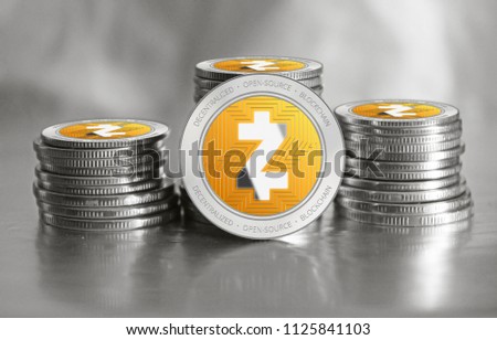 Zcash (ZEC) cryptocurrency. Stack of silver with orange coins. Cyber money.