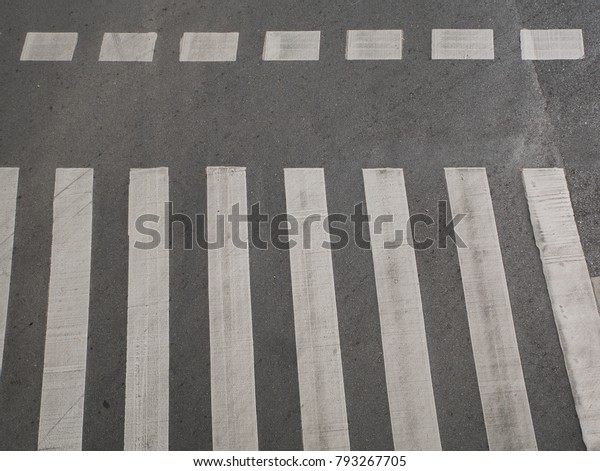 Zebra cross walk on asphalt\
road.