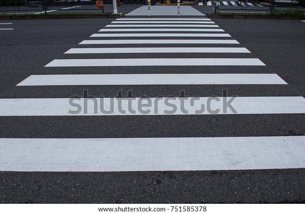 Zebra crossing line on the road background, to\
cross the road safely\
concept.
