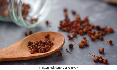 zechuan peppercorn on a wooden spoon. Chinese pepper is a spice commonly used in the Sichuan cuisine of China's southwestern Sichuan Province