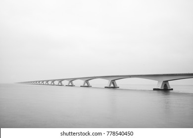 The Zeelandbrug (Zeeland Bridge) in the Dutch province of Zeeland, photographed in black & white, long exposure shot.