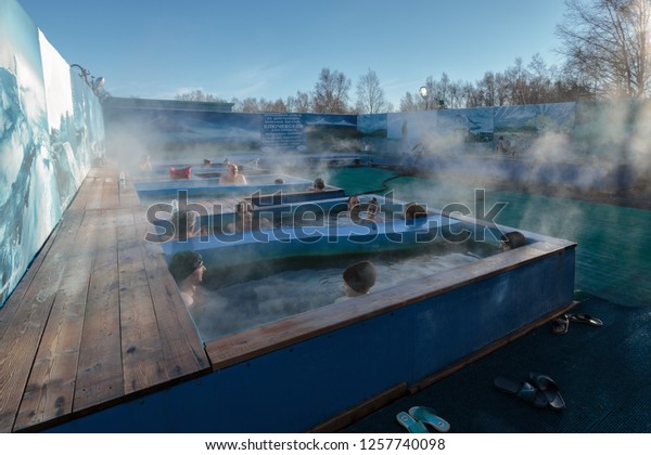ZELENOVSKIE OZERKI, KAMCHATKA REGION, RUSSIAN\
FAR EAST - DECEMBER 25, 2016: Men and women enjoying bathing\
relaxed in spa pool with natural thermal mineral water having\
balneotherapy\
properties.