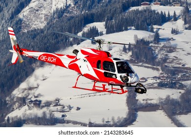 Zell am See, Austria - February 14, 2018: Commercial helicopter at airport and airfield. Rotorcraft. General aviation industry. Civil utility transportation. Air transport. Fly and flying.