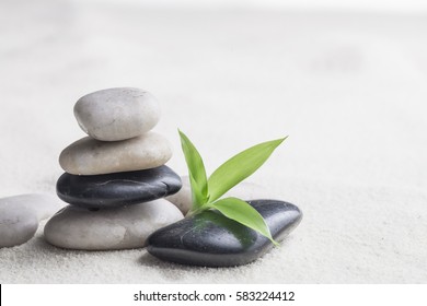 zen basalt stones and bamboo on the sand