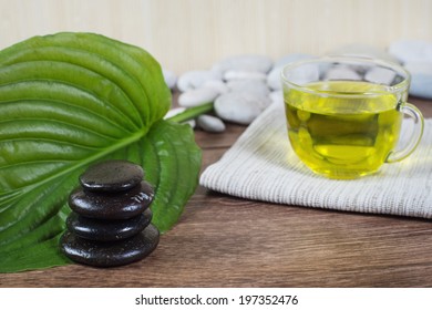 zen basalt stones and cup of tea on the wood - Powered by Shutterstock