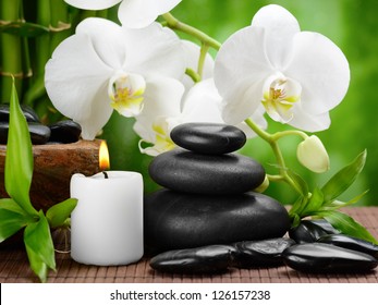 zen basalt stones and orchid on the wood
