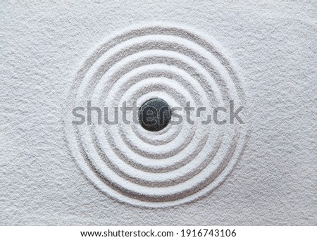 Zen circle in white sand pattern