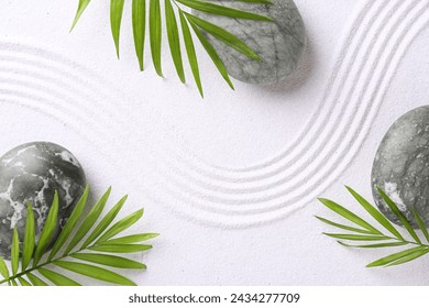 Zen concept. Stones, leaves and pattern on white sand, flat lay - Powered by Shutterstock