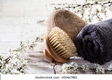 Zen Detox Still-life - Body Brush And Towel Over Stone, Fresh White Spring Flowers And Mineral Limestone Background For Body Care Spa Treatment
