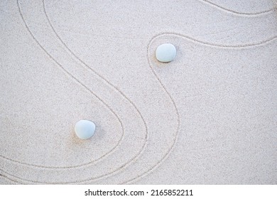 Zen Garden Japanese pattern on white sand background. buddhism texture wave on desert nature at coast of shore. top view line abstract on beach with stone. Purity Meditation calm or lifestyles spa. 