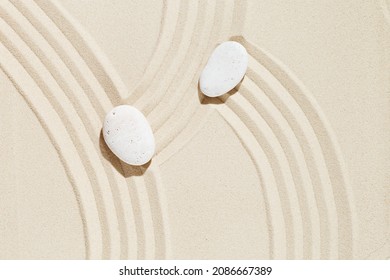 Zen garden meditation sandy background with copy space. White stone and lines on sand for relaxation balance and harmony spirituality or spa wellness. Top view. - Powered by Shutterstock