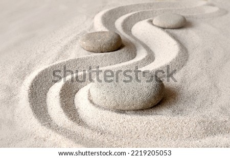 Zen garden meditation stone background with stones and lines in sand for relaxation balance and harmony spirituality or spa wellness.